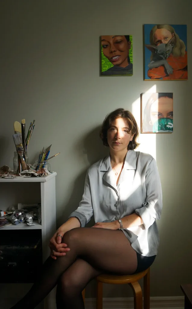 Portrait of Montreal portrait artist Jane Aimée Soleil in her studio, surrounded by her artwork exploring femininity, emotion, and nature.